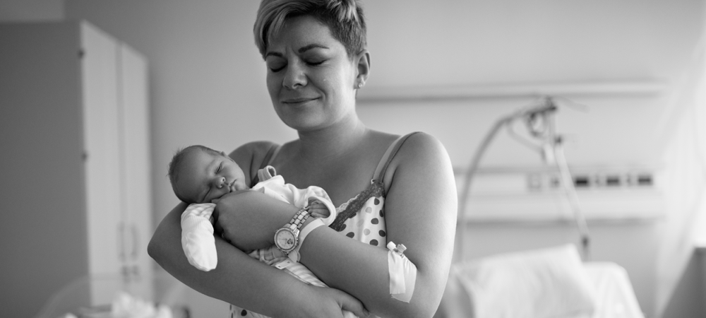 Mom holding sleeping baby